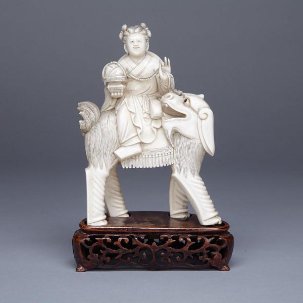 Appraisal: Ivory Carved Boy and Mythical Beast Group Circa Carved in