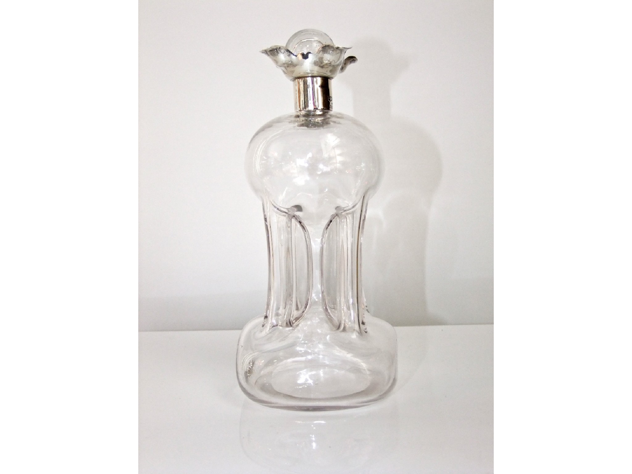 Appraisal: An hour glass shaped decanter with silver collar - Mappin