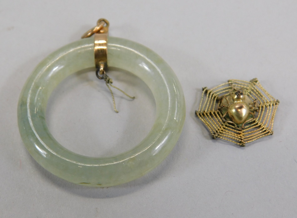 Appraisal: A jade pendant with central spider pendant yellow metal marked