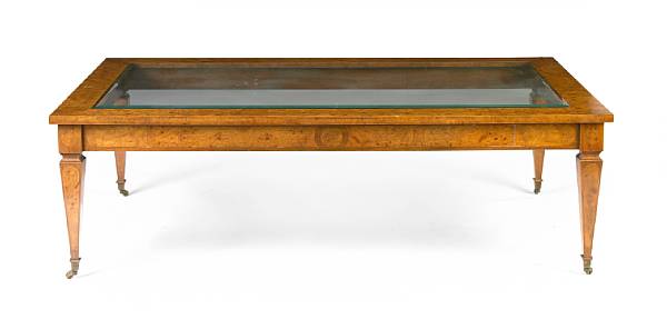 Appraisal: A Neoclassical style figured walnut coffee table with glass top