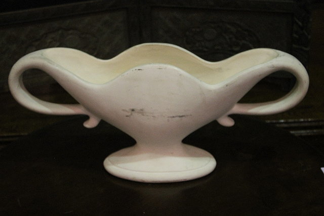 Appraisal: A WHITE GROUND CERAMIC VASE of oval form with shaped