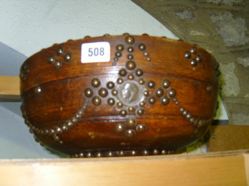 Appraisal: An oak bowl of circular form with applied studded finish