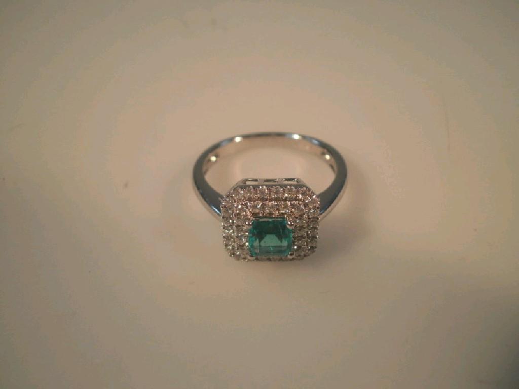 Appraisal: An ct white gold emerald and diamond cluster dress ring