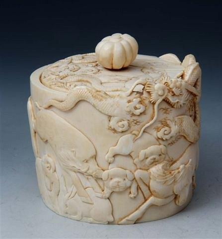 Appraisal: A JAPANESE IVORY CARVED CYLINDRICAL OVAL BOX and cover with