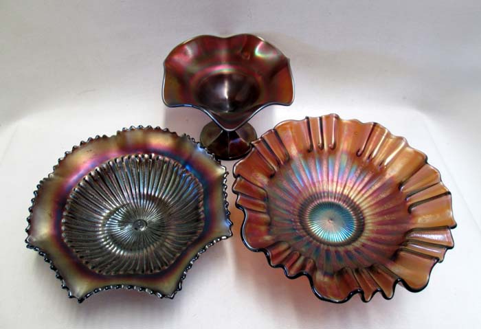 Appraisal: THREE PIECES OF STRETCH GLASS HOLLOW WARE in colored glass