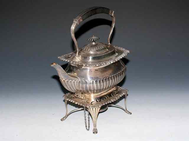 Appraisal: AN EDWARDIAN SILVER KETTLE ON STAND oval pot with fluted