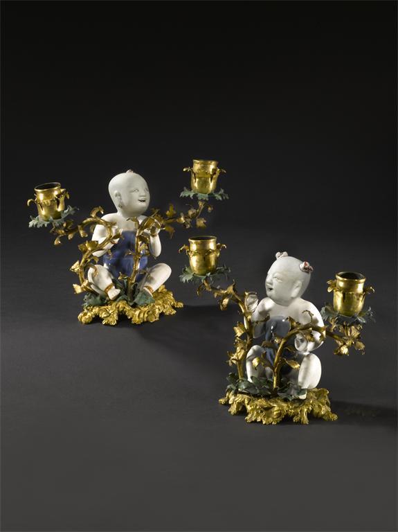 Appraisal: A rare pair of porcelain and ormolu mounted candle holders