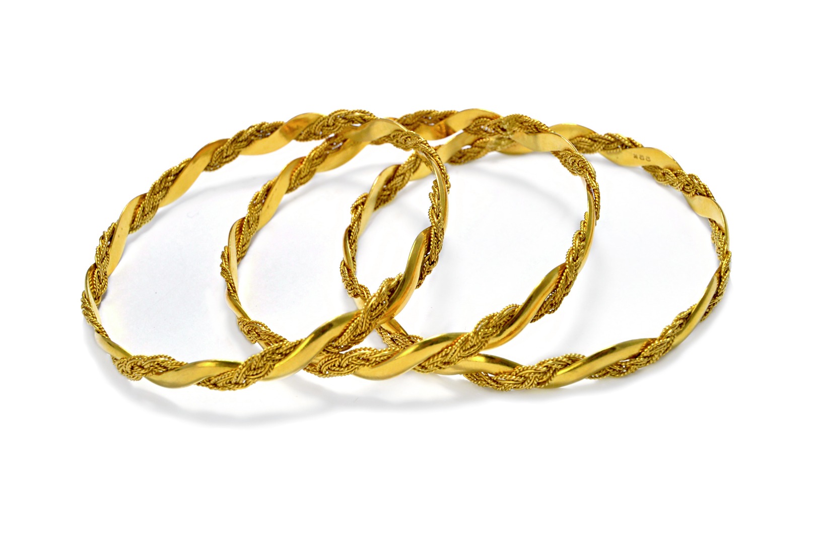 Appraisal: Three gold circular bangles each in a ropetwist interwoven wirework