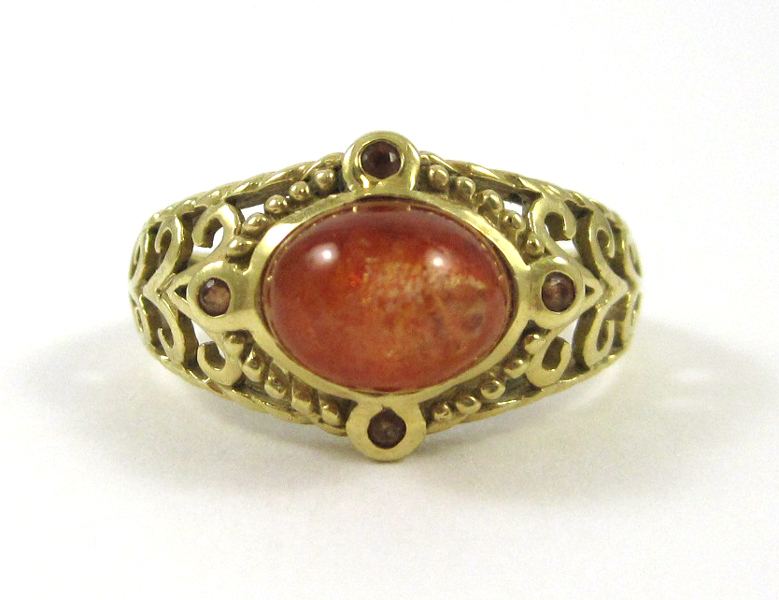 Appraisal: SUNSTONE AND FOURTEEN KARAT GOLD RING featuring an oval sunstone