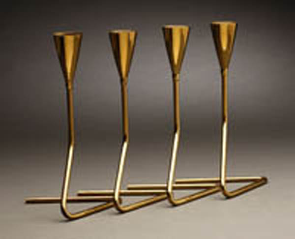 Appraisal: Four Werkstatte Carl Aubock brass candlesticks Four Werkstatte Carl Aubock