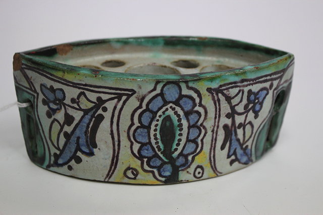 Appraisal: A SMALL NAVETTE SHAPED IZNIK STYLE TIN GLAZED POTTERY INKWELL