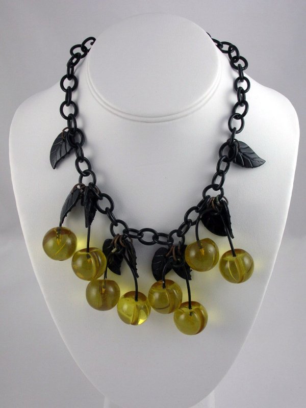 Appraisal: Bakelite and Lucite cherry necklace having black Bakelite link chain