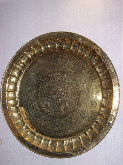 Appraisal: A large Indian brass tray engraved profusely with leaf scrolls