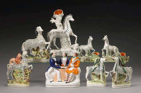 Appraisal: An assembled grouping of seven Staffordshire pottery zebras second half