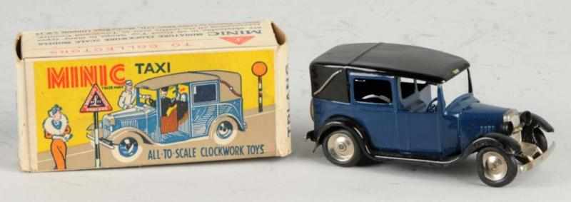 Appraisal: Metal Triang-Minic Taxi Cab Wind-Up Toy Description Working Includes original