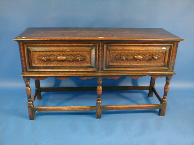 Appraisal: A Jacobean style oak dresser base with two moulded panel