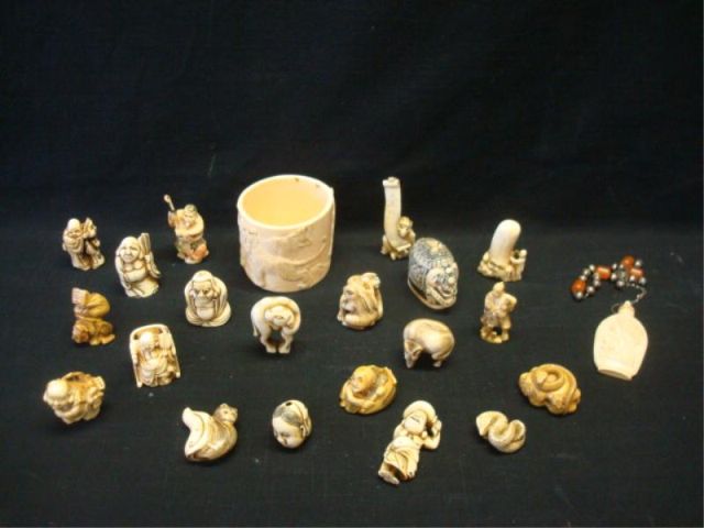 Appraisal: ivory bone carved netsukes along with carved lion container Dimensions