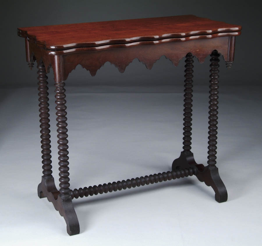 Appraisal: GOTHIC REVIVAL MAHOGANY CARD TABLE The turn fold over shaped