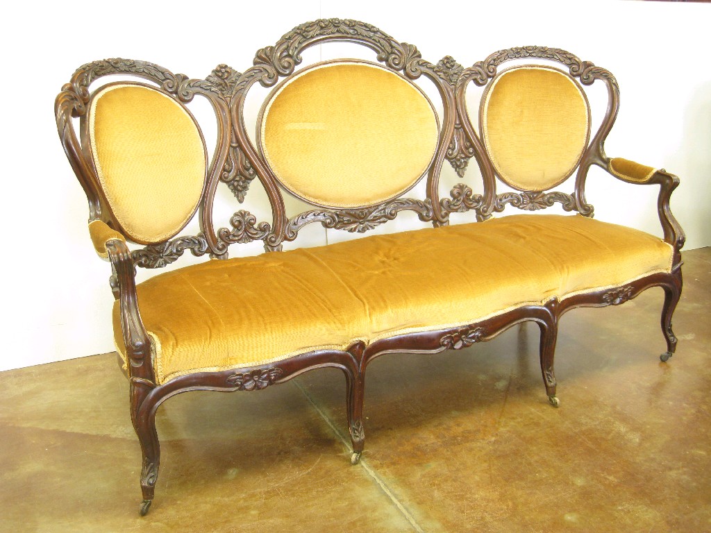 Appraisal: A Victorian mahogany Settee triple back with carved scrollwork