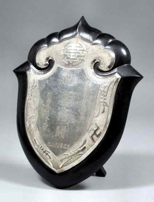 Appraisal: A Chinese rosewood and silvery metal shield pattern plaque the