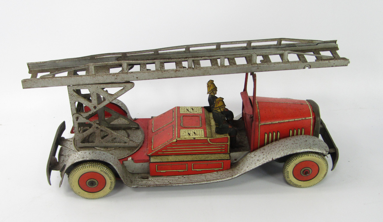 Appraisal: An English tin plate clockwork fire engine with two firemen