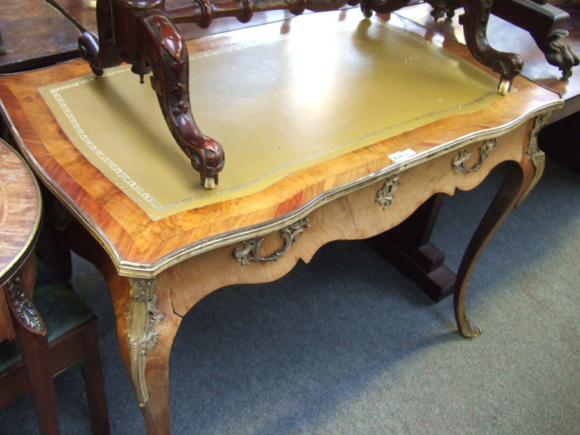 Appraisal: A walnut and kingwood bureau plat the shaped top with