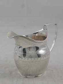 Appraisal: A Georgian silver service cream jug with reeded rim and