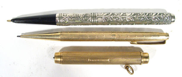 Appraisal: Two gold propelling pencils in engine turned cases and a