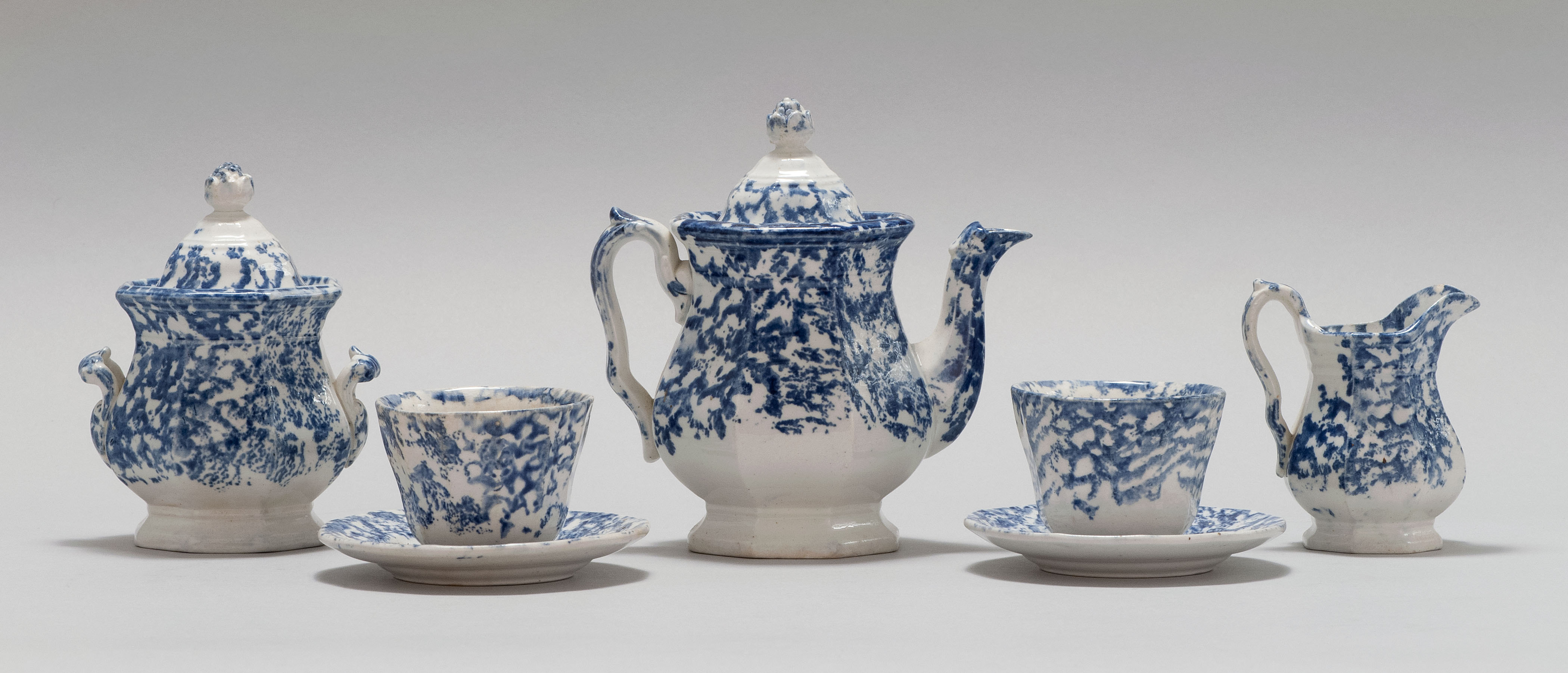 Appraisal: SEVEN-PIECE BLUE AND WHITE SPATTERWARE CHILD'S TEA SET Late th