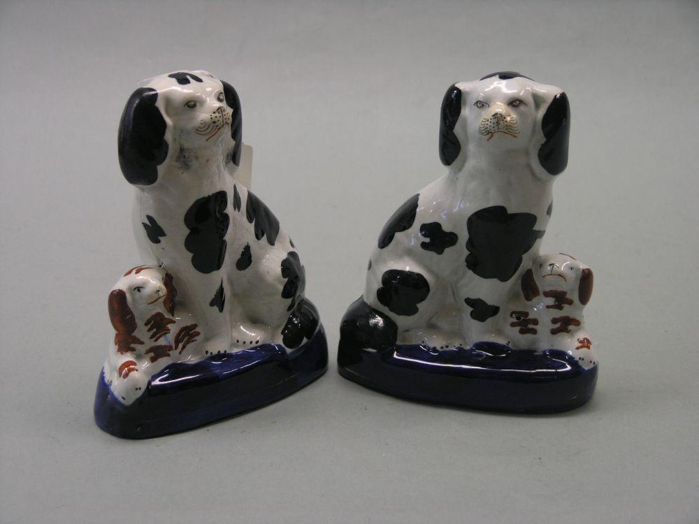 Appraisal: A pair of Victorian Staffordshire pottery spaniel groups each a