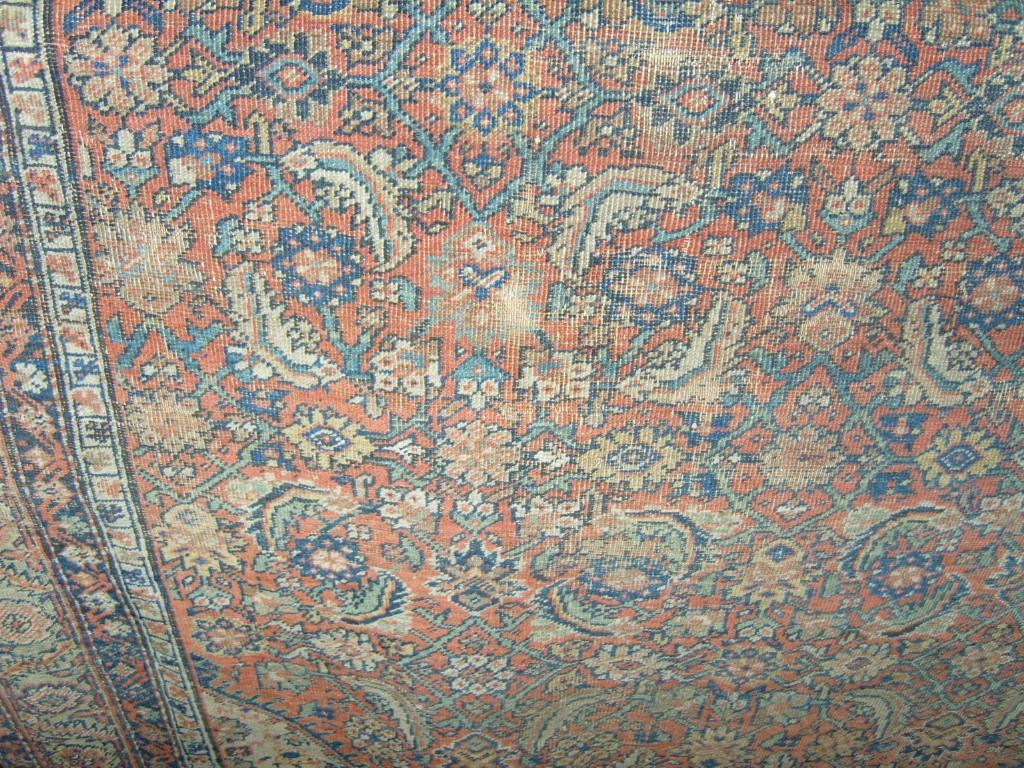 Appraisal: A red ground eastern wool rug with stylised floral decoration