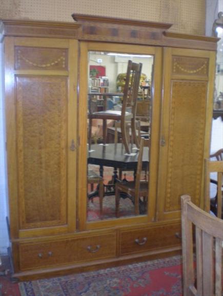 Appraisal: An Edwardian mahogany triple mirror door wardrobe with marquetry and