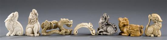 Appraisal: Group of carved and tinted ivory bone dragon shihi netsukes