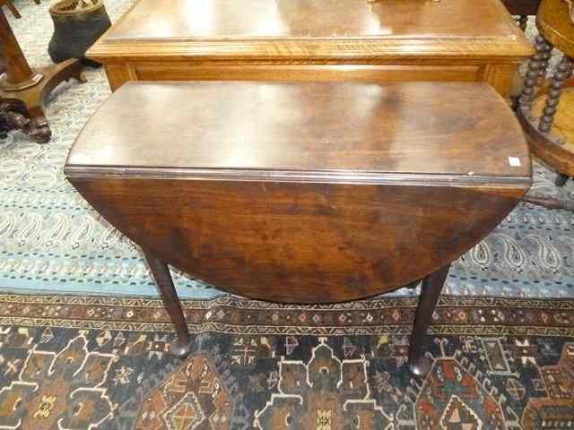 Appraisal: A GEORGE II 'RED WALNUT' OVAL SUPPER TABLE with drop