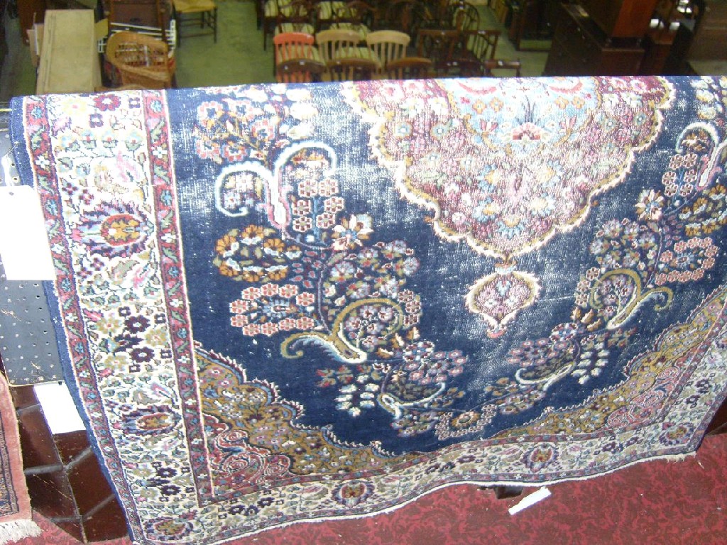 Appraisal: A blue ground Persian rug central medallion with floral detail