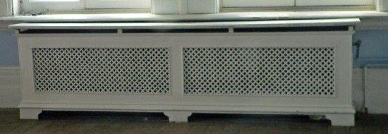 Appraisal: A double pierced cast radiator surround with marble top on