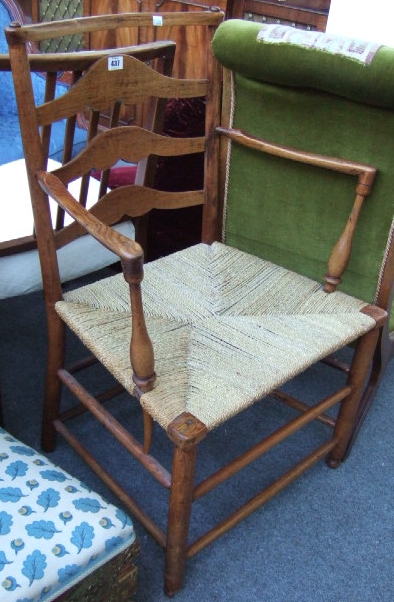 Appraisal: A th century ash open arm ladder back chair with