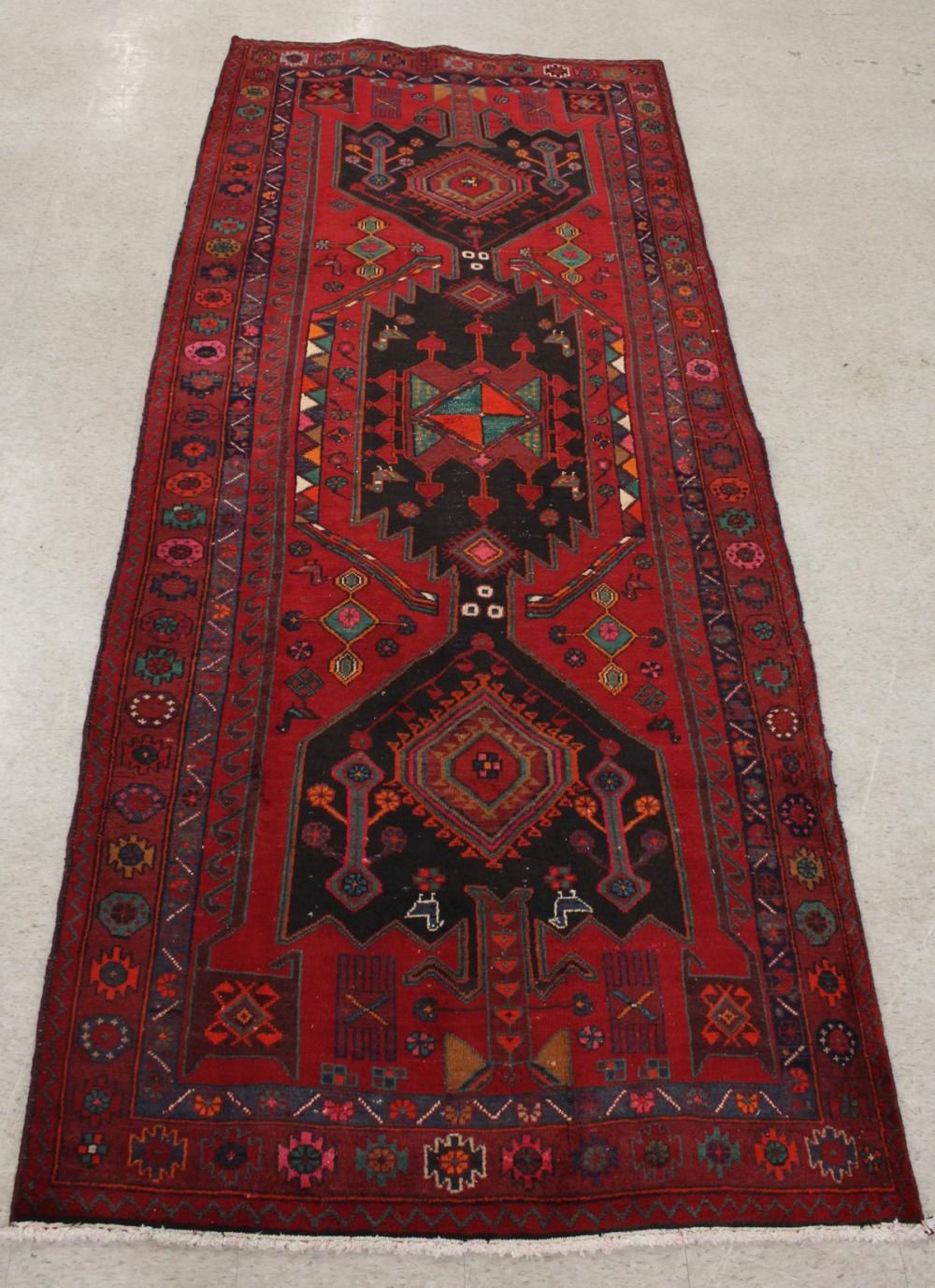 Appraisal: HAND KNOTTED PERSIAN TRIBAL CARPET geometric and stylized floral design