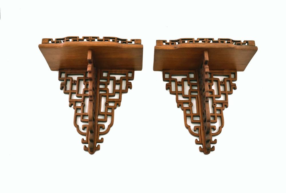 Appraisal: PAIR OF CHINESE FRET-CARVED HARDWOOD BRACKETSThe reddish-brown wood with a