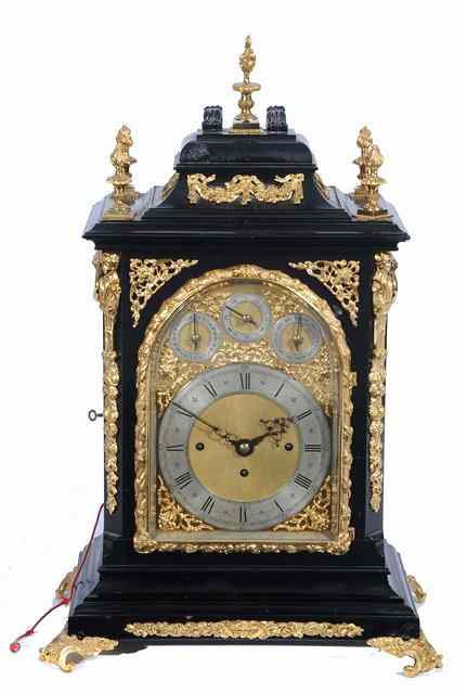 Appraisal: AN EBONISED TABLE CLOCK the arched brass dial with silvered