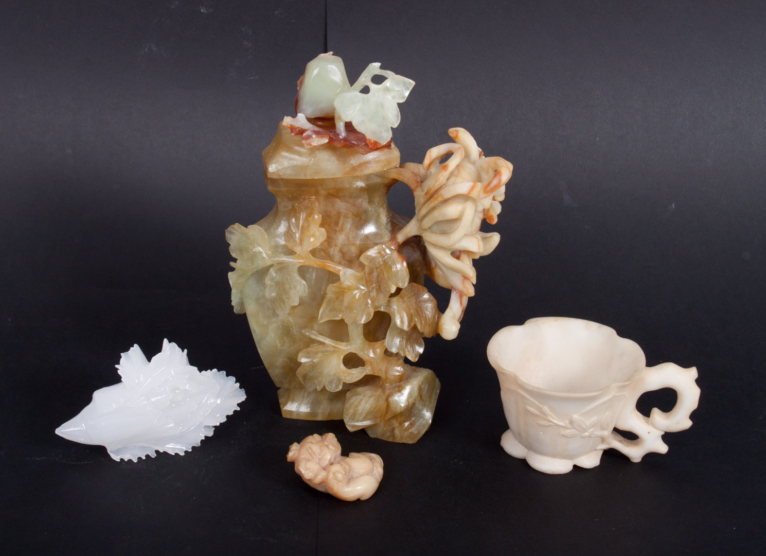 Appraisal: Four oriental carved jade and hardstone objects including jade urn