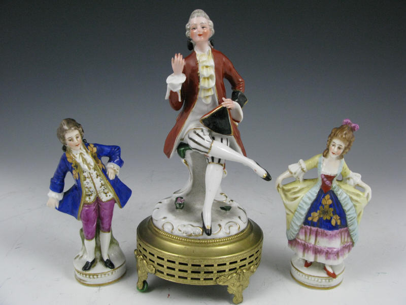 Appraisal: Group of Three German Dresden Porcelain Figures the pair the