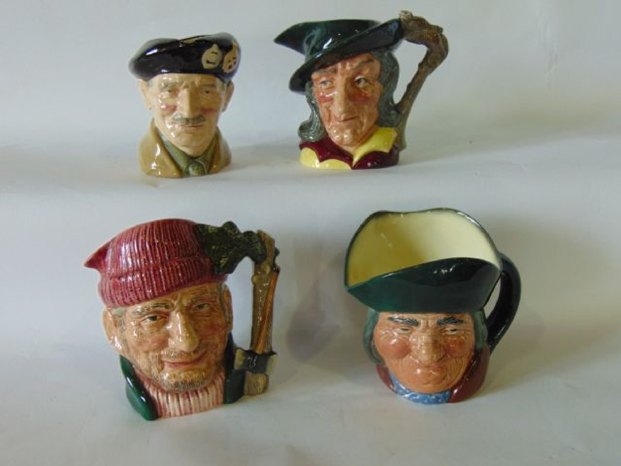 Appraisal: A collection of four large Royal Doulton Character Jugs -