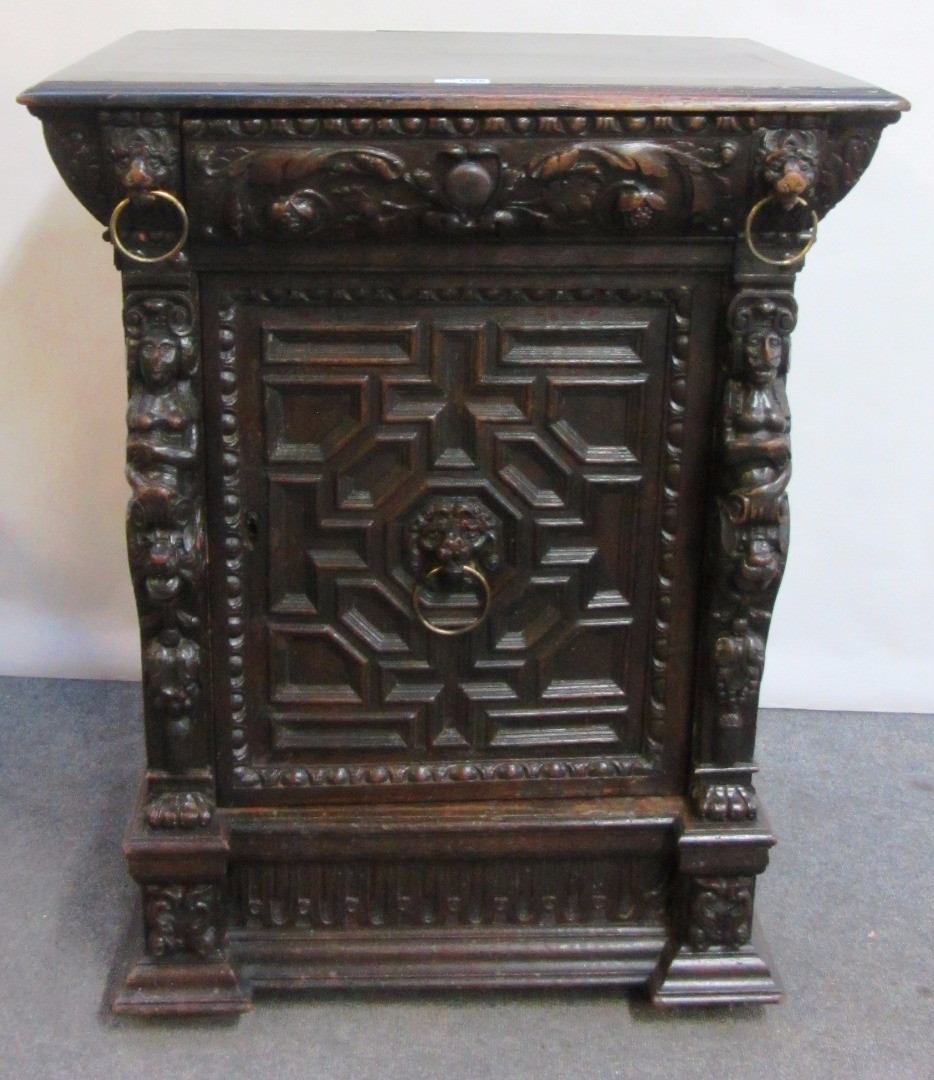 Appraisal: A Victorian carved oak side cabinet with single drawer over