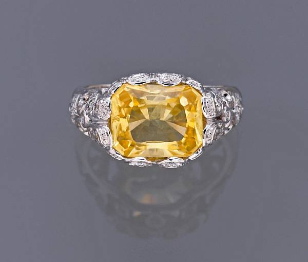 Appraisal: A yellow sapphire and diamond ring sapphire weighing an estimated