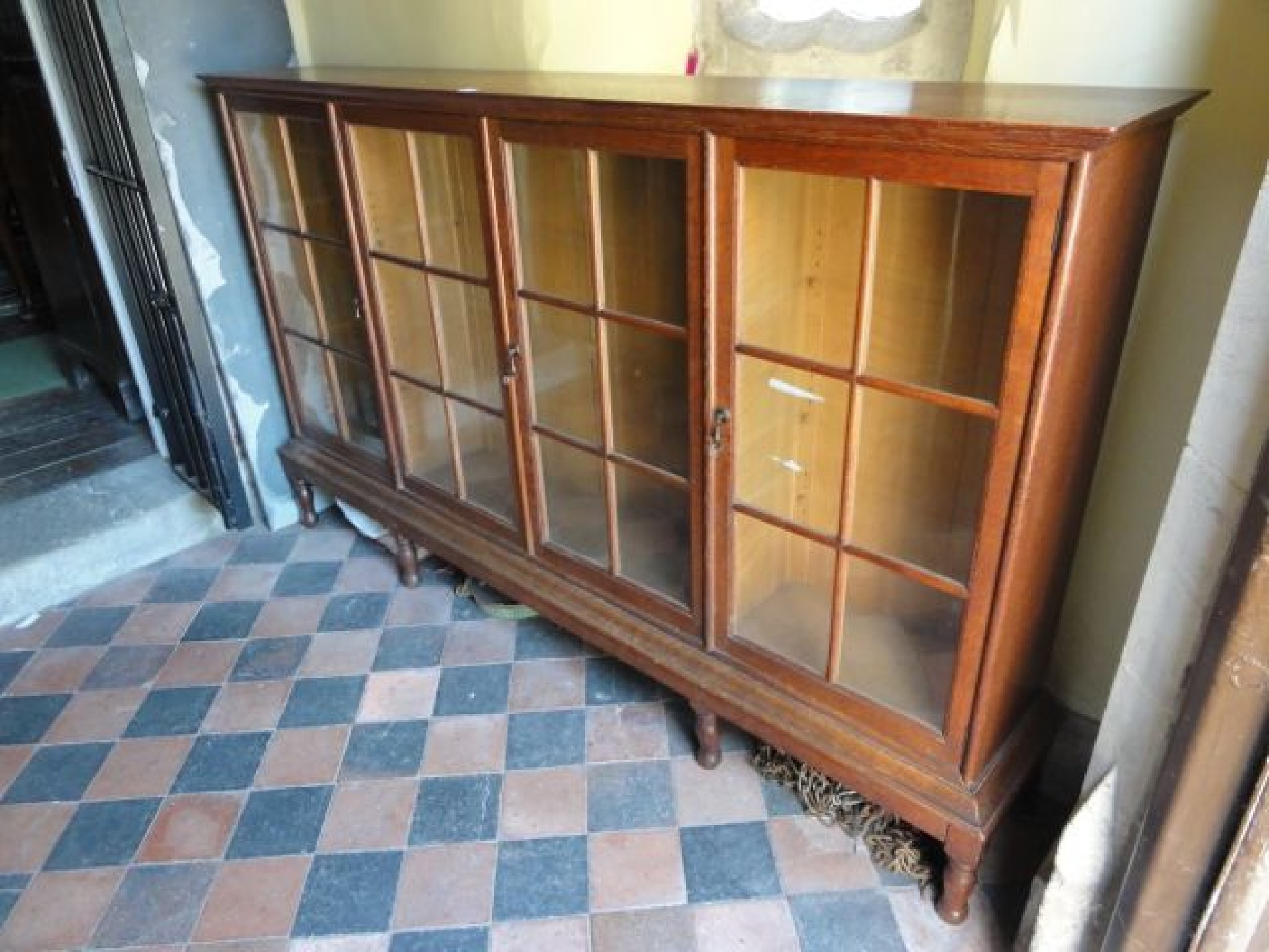 Appraisal: An early th century low oak bookcase enclosed by four