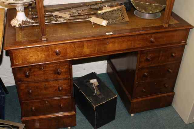 Appraisal: A MAHOGANY KNEE-HOLE PEDESTAL DESK fitted seven drawers