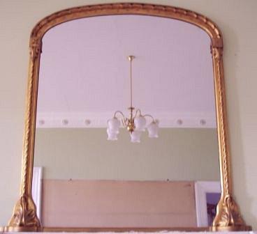 Appraisal: An early Victorian arch top overmantel mirror with scalloped arch