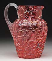 Appraisal: PELOTON WATER PITCHER Cranberry glass with colored shreds of yellow