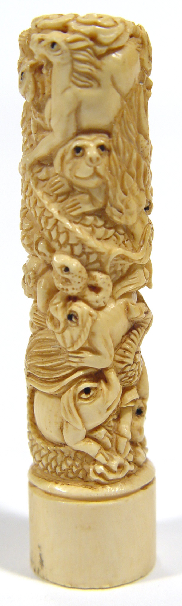 Appraisal: Oriental ivory column shaped Netsuke predominantly carved with animals climbing